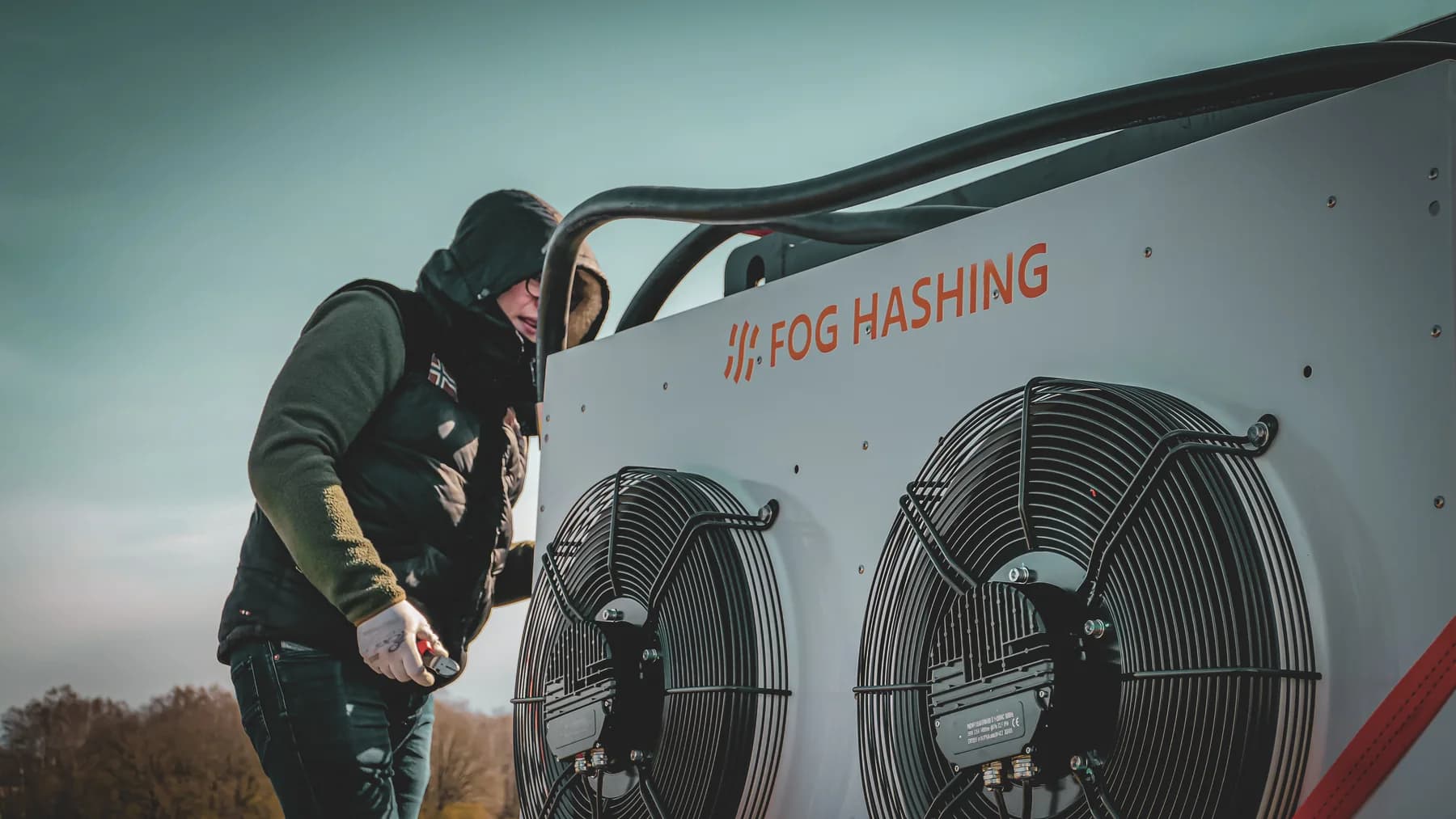 Technician working on a Fog Hashing cooling and heat-transfer unit