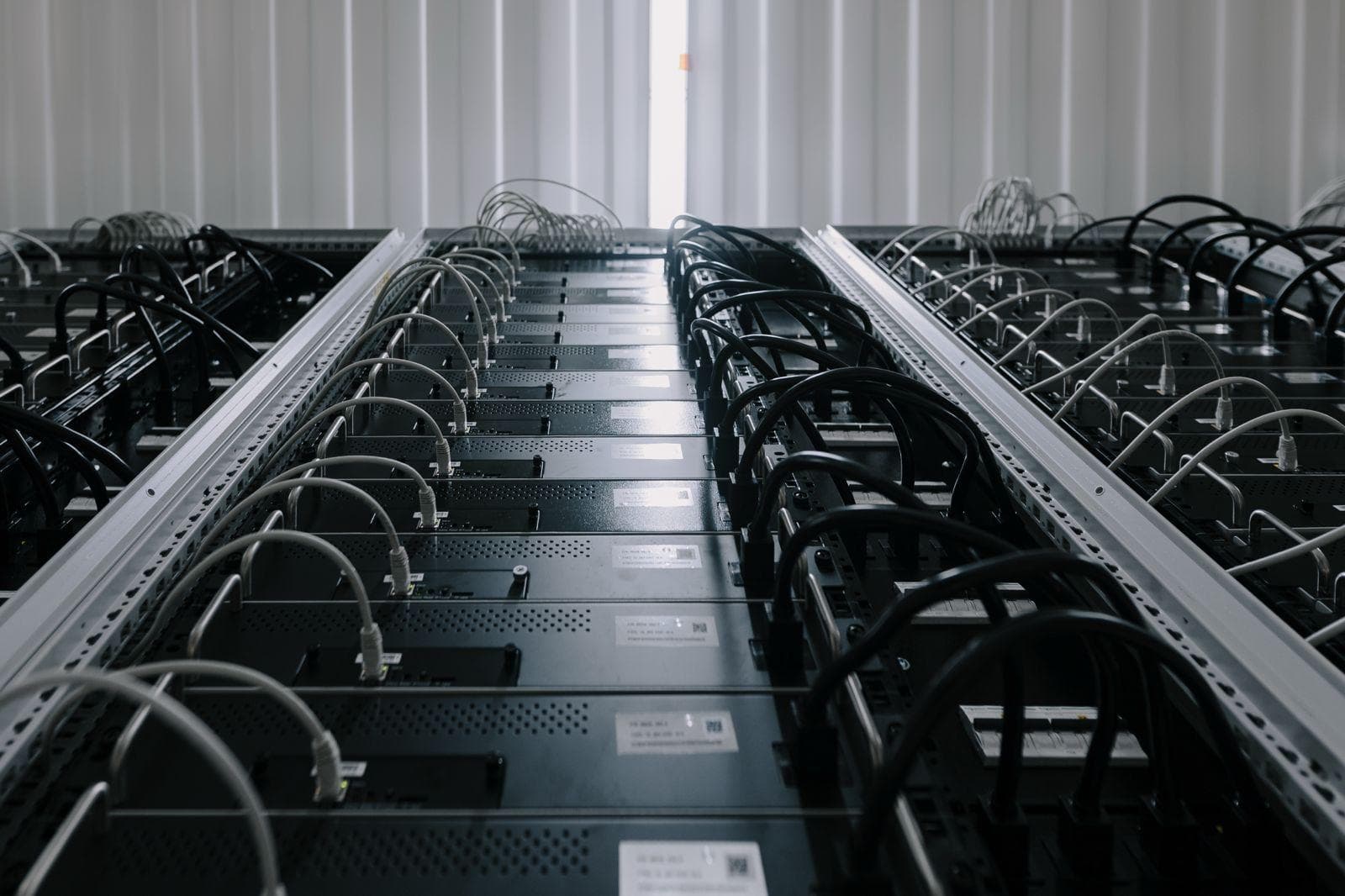 Symmetrical rows of connected ASIC miners in a managed facility