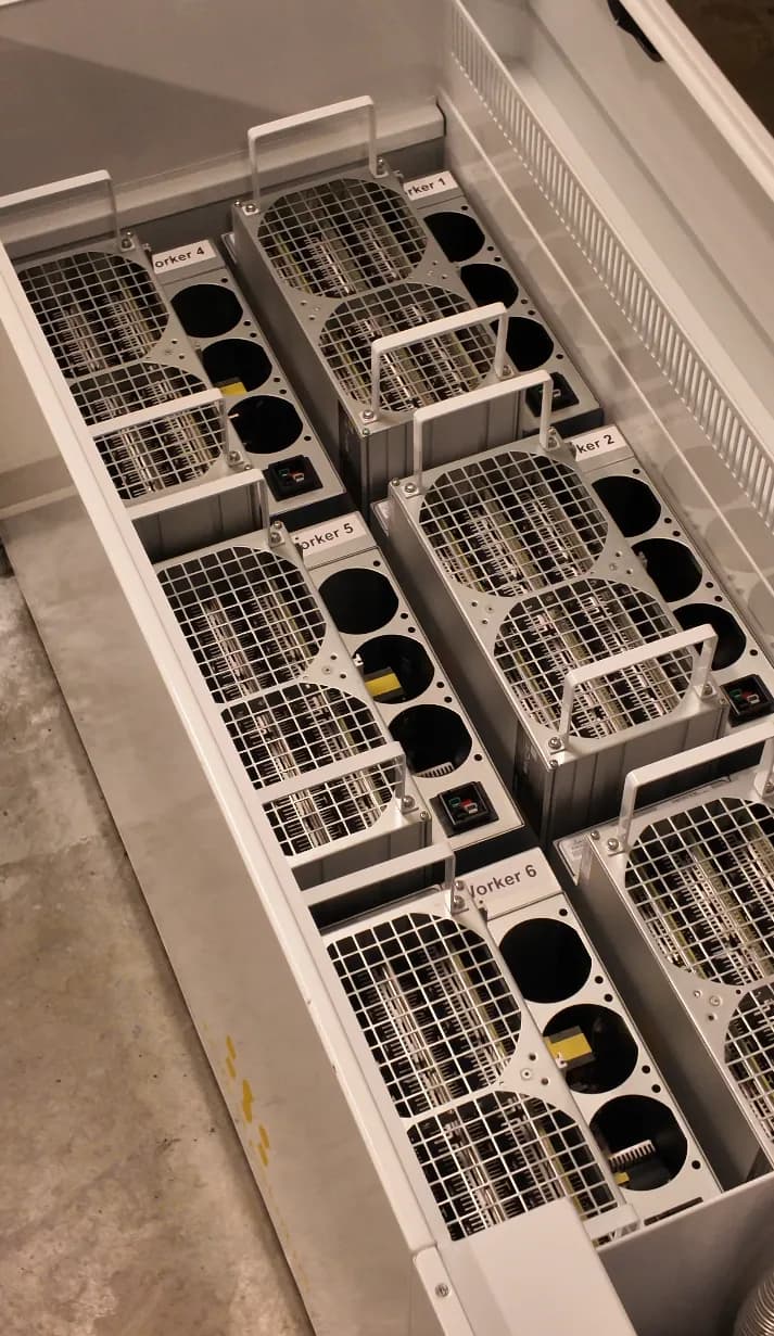 Several ASIC miners installed in an immersion system